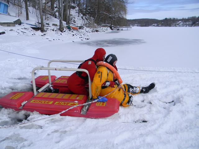 2nd Lieutenant Wassil explaining how to secure the victim to the rescue sled