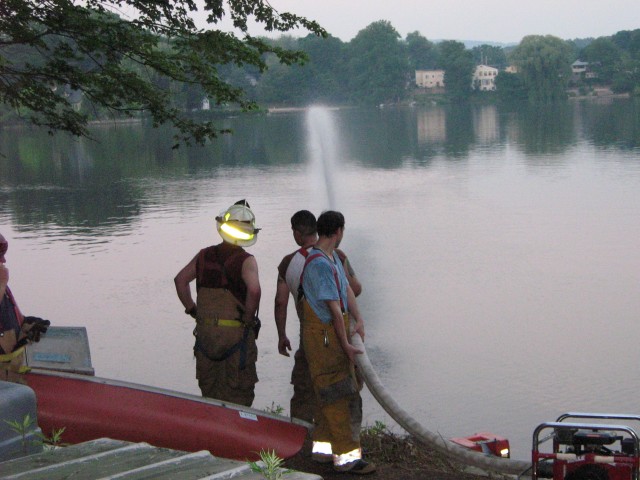 FF's Caruana and Turtenwald receive orders from !st Lieut. Keeler at the water source.