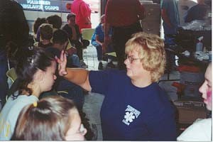 Firefighter Kathy Brown applying makeup on victims